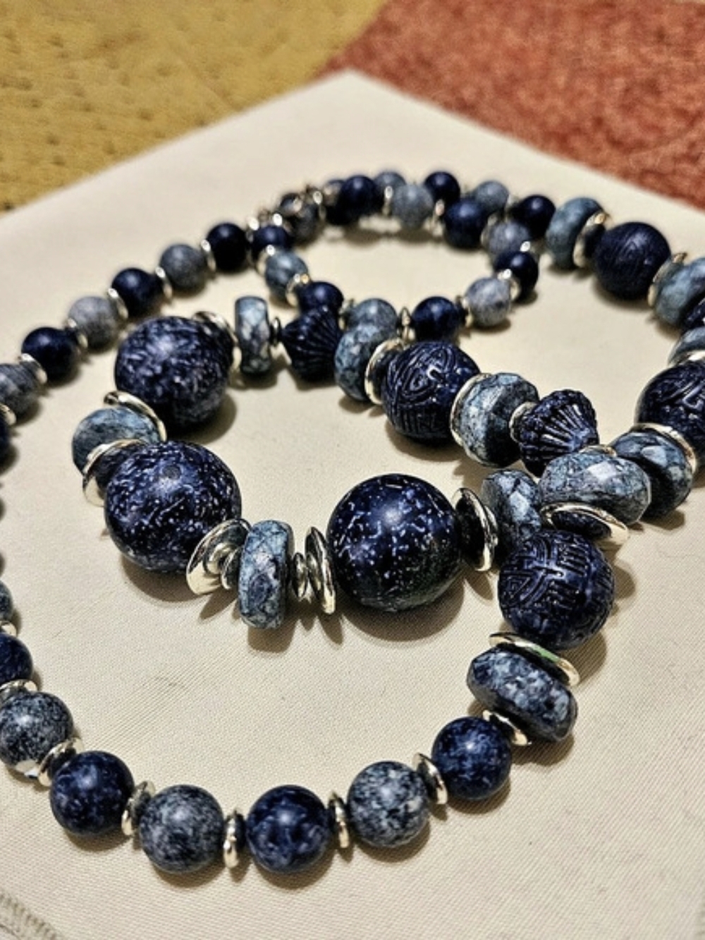 Blue Beaded necklace featuring Round and Carved Textured Beads